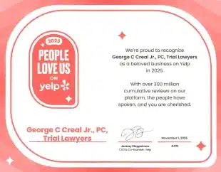 Pink certificate badge that reads 'People Love Us on Yelp' for 2023, awarded to George C. Real Jr., PC, Trial Lawyers, with signature block and decorative stars.