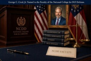 Formal courtroom-style desk with a podium labeled NCDD National College for DUI Defense, a framed portrait, stacked law books, scales of justice, and a 'NCDD Faculty' placard on the desk.